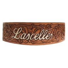 a brown leather belt with the word larcelle on it's side and an ornate