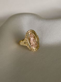 DESCRIPTIONA statement ring featuring the Virgin Mary in 14k rose gold surrounded by 14k yellow gold. A look: stack and layer this with other pieces from our Religious Edit for a full effect. This piece requires custom sizing, making it final sale. DETAILS- always made in 14k yellow and rose gold Virgin Mary Ring, Custom Gold Jewelry, Quinceanera Jewelry, Xoxo Jewelry, Catholic Jewelry, The Virgin Mary, Magical Jewelry, Jewelry Accessories Ideas, Dope Jewelry