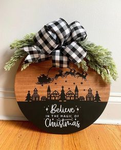 a wooden sign that says believe in the magic of christmas