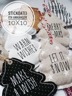 christmas ornaments with words on them are displayed in front of a white table cloth background