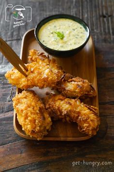 chicken wings with dipping sauce on a wooden tray