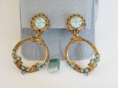 Beautiful Czechoslovakia earrings, with Robin's egg glass stones. Brass filigree in antique gold tone, with small turquoise colored stones. Clip on dangle earrings, with beautiful details.  The earrings are in very good vintage condition, few signs of age and wear.   The earrings are approx. 2 inches long and 1 inch wide. In very good vintage condition.  Please note this is a vintage item. I try to describe the items the best I can, but the photos are the best possible description. Please contac Turquoise Costume Jewelry Earrings For Gift, Turquoise Clip-on Round Jewelry, Turquoise Round Clip-on Jewelry, Turquoise Clip-on Jewelry Gift, Turquoise Clip-on Jewelry For Gift, Vintage Turquoise Round Earrings, Turquoise Clip-on Round Earrings, Czech Art, Brass Filigree