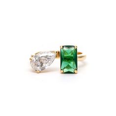 18K Gold Clad Emerald Crystal + Cubic Zirconia Open Band Ring This Rivka Friedman 18K Gold clad open band ring features a faceted prong set rectangular Emerald crystal and a faceted prong set pear shape Cubic Zirconia stone. Measures: 10mmx6mm width Emerald Crystal: 10x6mm CZ: 10x6mm Emerald Crystal, Linking Rings, Ring Sale, Gold Band Ring, Cubic Zirconia Rings, Cz Ring, Statement Bracelet, Earring Sale, Ring Size Guide