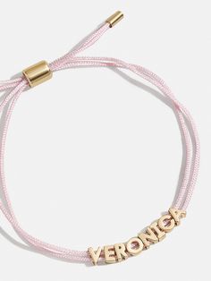 a pink cord bracelet with the word veronick engraved on it