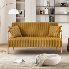 a living room with a couch, lamp and bookshelf