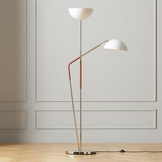 the floor lamp has two white lamps on it