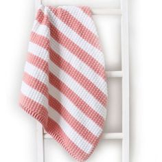 a pink and white striped towel hanging on the wall