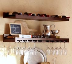 wine glasses are lined up on the shelf