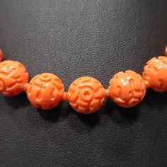 *Description: This is a great molded floral Lucite beaded necklace in coral orange with a single strand of beads and matching clip molded floral button earrings from the 1950s. The jewelry vintage set is very light in weight and would be a great necklace earring set to wear with any outfit. This would be a great addition to your vintage jewelry collection or make a great vintage gift! *Approximate Measurements: Necklace Length - 16 Inches, Largest Bead - 10mm, Earrings Length & Width - 1 1/8 Vintage Coral Round Bead Jewelry, Vintage Coral Necklaces With Large Beads, Vintage Orange Carved Jewelry, Orange Carved Vintage Jewelry, Vintage Carved Orange Jewelry, Vintage Coral Beaded Necklace As Gift, Vintage Orange Beaded Necklaces For Formal Occasions, Vintage Orange Necklace With Round Beads, Vintage Orange Round Beads Necklace