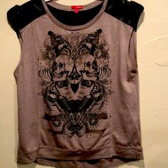 Fun Rocker Tee By Bongo Featuring A Skull/Rock Design With Black & Metal Stud Embellishments. Taupe Color With Faux Leather Across Shoulders And Back With Buckle Design. Looks Never Worn. Size Xl. Pit To Pit 21”. Shoulder To Hem 24” Casual Black Leather Top, Casual Leather Tops For Spring, Skull Print Tops For Fall Concert, Brown Leather Casual Tops, Casual Leather Tops With Short Sleeves, Casual Leather Top With Short Sleeves, Casual Leather Short Sleeve Tops, Casual Brown Leather Top, Casual Brown Leather Tops