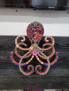 an octopus made out of beads and jewels