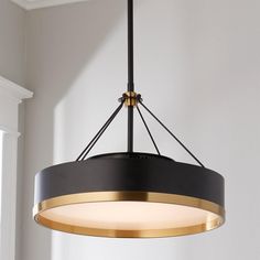 a black and gold chandelier hanging from the ceiling in a room with white walls