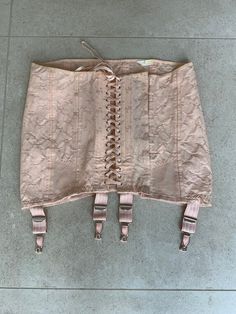 Vintage peach pink cotton jacquard Spirella girdle corset. Cotton front laces. Boned section beside front lacing. Hook and eye fastening. 4 non-removable suspenders. Adjustable waist up to 35 inches and hips up to 40 inches approx. Excellent vintage condition.  Barely worn and has been in storage for many years. Dimensions taken flat across width of girdle ( laces tied tightly) Waist.      33. Inches Hips.        36.Inches Front Length.   11.5. Inches Back Length.    13 Inches The girdle is adju Pink Lace Trim Underbust Corset, Pink Underbust Corset With Lace Trim, Pink Lace Underbust Corset, Vintage Corset Belt For Spring, Pink Overbust Corset With Lace Trim, Vintage Overbust Corset, Pink Fitted Vintage Corset, Vintage Beige Underbust Corset, Vintage Beige Overbust Corset