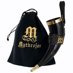 a pair of black boots with gold lettering on them and a drawstring bag