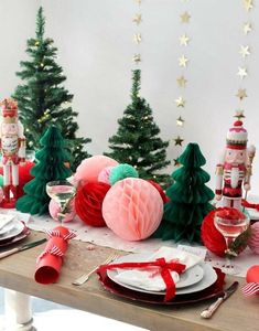 the table is set for christmas dinner with red and green decorations