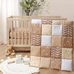 a baby crib with a teddy bear next to it and a blanket on the floor