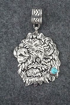 "This impressive Kingman turquoise and sterling silver pendant in the shape of a Buffalo was made by Navajo silversmith Richard Singer. The back is signed R Singer and stamped .925. Length: 4 3/8\" Width: 2 1/2\" Free shipping on all orders! We ship with USPS and always include tracking. All orders ship within a day of payment. Returns are accepted up to 30 days after you receive your order. Just send us a message. Our shop offers cash back or store credit. The item must be returned in new condi Etched Turquoise Sterling Silver Jewelry, Western Style Collectible Turquoise Sterling Silver Necklace, Handmade Western Silver Turquoise Necklace, Western Style Silver Turquoise Necklace As Gift, Southwestern Engraved Turquoise Necklace In Sterling Silver, Western Style Silver Turquoise Necklace With Large Pendant, Engraved Silver Southwestern Turquoise Necklace, Engraved Silver Turquoise Necklace In Southwestern Style, Sterling Silver Artisan Turquoise Necklace