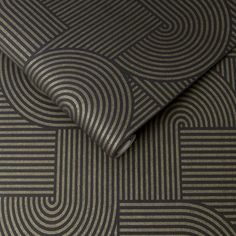 a close up view of a black and grey wallpaper with wavy lines on it