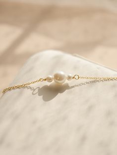 If you are interested in placing a bulk order (50+ pieces), please message us for special pricing.-- 925 silver pearl bracelet, dainty gold bracelet, delicate pearl bracelet, bridesmaid bracelets-- ► DETAILS  -925 sterling silver + 14k gold -Freshwater pearls -Length: 6 inches + 2 inches chain extender ►Heavenly Materials Our jewellery pieces are delicately handcrafted with gold-fill, sterling silver, stainless steel and gold-plating, combining rich, warm tones with an effortless shine.  ►Prompt Dainty Pearl Bracelet With Pendant As Gift, Dainty Pearl Bracelet With Pendant, Elegant Bracelets With Pearl Pendant As Gift, Elegant Bracelet With Pearl Pendant As Gift, Elegant Pearl Pendant Bracelets As Gift, Elegant Pearl Bracelet With Delicate Chain, Pearl White Bracelets With Pearl Pendant For Weddings, Delicate Pearl Pendant Bracelet As Gift, Dainty Pearl Charm Bracelet For Bridesmaids