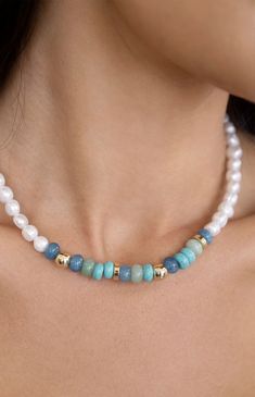 Online Only! Capture the essence of a perfect beach day with Ettika's Beach Day Pearl & Blue Gemstone Necklace, featuring a faux pearl beaded design adorned with gold, turquoise, and mixed gemstone beads. This necklace radiates coastal charm and elegance, making it an ideal accessory for summer adventures and casual outings alike.


	18k gold plated
	Freshwater pearls
	Mixed blue gemstones
	15" with 3" extender
	Lobster clasp closure Beach Pearl Beaded Necklaces With Spacer Beads, Pearl Beaded Necklaces With Spacer Beads For Beach, Pearl Necklaces With Spacer Beads For Beach, Round Pearl Bead Jewelry For Vacation, Vacation Beaded Pearl Necklace, Bohemian Single Strand Pearl Necklace For Beach, Summer Beach Beaded Necklaces With Gemstone Beads, Bohemian Blue Pearl Necklace For Beach, Beach Pearl Necklace With Colorful Beads In Gold