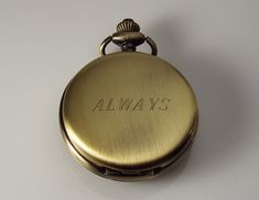 "Personalized pocket watches make great gifts for a birthday, Christmas, graduation, your best man or groomsmen, father of the bride or groom, Father's day, a retirement, or any special occasion! This beautiful watch has a lovely bronze finish, and with the jeweled mechanical movement it truly looks vintage! The front cover has a center cut out with factory embossed roman numerals, and is framed with fancy scrolls. The back cover is smooth and ready to be engraved with a monogram, name, initials Harrisburg Pa, Pocket Watches, Roman Numeral, Mechanical Movement, Father Of The Bride, Beautiful Watches, Dust Cover, Roman Numerals, Hand Engraving