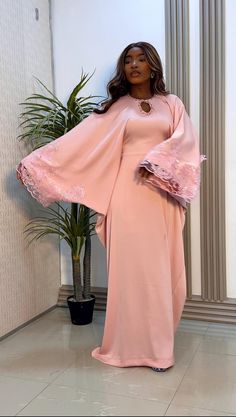 Indulge in elegance with our Luxury Silk Bubu in Peach. Crafted with the finest silk, this stunning gown features intricate lace detailing and a unique cutout. Elegant Pink Maxi Dress For Banquets, Pink Lace Evening Dress For Wedding Guest, Pink Lace Long Sleeve Evening Dress, Pink Long Sleeve Lace Evening Dress, Long Sleeve Pink Lace Evening Dress, Pink Floor-length Dress With Lace Trim, Elegant Peach Maxi Dress For Wedding, Elegant Long Sleeve Blush Dress, Elegant Peach Evening Dress For Wedding