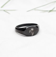 "Elevate your everyday style with our Personalized Birth Flower and Name Signet Ring. This premium steel jewelry piece features a customizable birth flower and name, making it a heartfelt gift for her, be it for bridesmaids or Christmas. With anti-tarnish properties, it's both timeless and meaningful. How to order: 1) Choose the colour/finish of the ring from the drop-down (Silver / Gold) and choose the size of ring. Available in US sizes 5 to 12.  2) Choose the birth flower from the drop-down (12 Flowers available to choose from).  We have also included an option saying \"Other Flower\" - Please get in touch if you need any other flower apart from our list of 12 flowers.  In the personalisation box, please enter the name - max 9 characters.  Please note, that the name will be in caps as s Personalized Black Stainless Steel Rings, Black Stainless Steel Engraved Ring For Gift, Black Stainless Steel Engraved Ring As Gift, Minimalist Black Jewelry With Engraving Option, Customizable Black Promise Jewelry, Black Jewelry With Engraving Option For Anniversary, Personalized Black Signet Ring For Gift, Personalized Black Signet Ring Gift, Customizable Black Rings For Gifts