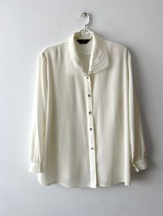 80s Women's formal blouse Pale Champagne sheer blouse Ivory white long sleeve top Vintage grandma blouse with shoulder pads Size Extra large N.B. Real color might slightly differ from picture. Estimated size: XL Measurements: (lying flat) Length - 29"/ 73.5 cm Shoulders:  17"/ 43.3 cm Sleeve - 24"/ 61 cm Pit to pit: 24"/ 61 cm Waist: 24"/ 61 cm Please check measurements to insure a proper fit. Remember to allow yourself some extra room for movement. You can compare these with something from your Sheer Sleeves Button-up Tops For Fall, Fall Sheer Sleeves Button-up Tops, Fall Button-up Top With Sheer Sleeves, Daywear Long Sleeve Blouse With Sheer Sleeves, Long Sleeve Blouse With Sheer Sleeves For Daywear, Spring Button-up Blouse With Sheer Sleeves, Classic Office Tops With Sheer Sleeves, Classic Sheer Sleeve Tops For Office, Elegant Peter Pan Collar Tops For Fall