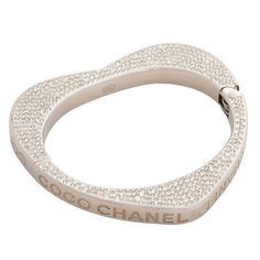 This bracelet has a heart shape and is encrusted with Swarovski crystals. "Coco Chanel” engraved on the sides. COLOR: Silver MATERIAL: Metal, crystal. MEASURES: Inside opening: 2.5” by 2”. Full bracelet diameter 3”, full circumference 9” ITEM CODE: 08 P COMES WITH: Chanel box. CONDITION: Good, a couple rhinestones missing. Faint hair line scratches. Made in Italy Luxury Diamond Heart Bracelet, Elegant Silver Heart Bracelet With Rhinestones, Luxury Silver Heart Bracelet With Cubic Zirconia, Luxury Silver Cubic Zirconia Heart Bracelet, Luxury Silver Diamond Heart Bracelet, Luxury Heart Cut Silver Bracelet, Luxury Rhinestone Crystal Bracelet, Luxury Silver Heart Cut Bracelet, Luxury Rhinestone Bracelets For Anniversary