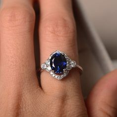 Sapphire ring sterling sivler oval cut anniversary ring | Etsy Classic Oval Sapphire Halo Ring, Classic Oval Sapphire Ring With Halo Design, Oval Lab-created Sapphire Jewelry With Halo Design, Elegant Oval Halo Ring With Lab-created Sapphire, Elegant Lab-created Sapphire Halo Promise Ring, Classic Sapphire Halo Ring With Gemstone, Elegant Sapphire Oval Halo Ring, Elegant Oval Sapphire Birthstone Ring, Elegant Oval Sapphire Halo Ring