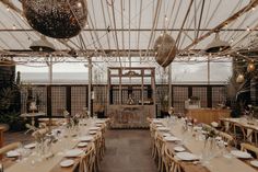 an indoor dining area with tables and chairs set up for a formal dinner or party