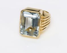 Aquamarine Ring. Vintage circa 1960's emerald cut aquamarine ring set in a ribbed 14K yellow gold mounting. Ring Size 9.5. Natural Aquamarine Weight: 22.85 Carats. Stone Measurements: 19.8 x 15.05 x 11.76. Ring Weight 21.5 Grams. Aquamarine Jewelry Antique Mens Rings, Aquamarine Gold Ring, Latest Gold Ring Designs, Emerald Cut Aquamarine Ring, Ribbed Ring, Gemstones Rings, Stone Ring Design, Aquamarine Ring Vintage, Rib Ring