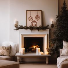 a living room filled with furniture and a fire place next to a christmas decorated tree