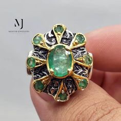 Ring Details - Natural Emerald - Main Stone Size: 8.00x6.00mm Approximate - 2.00mm Natural Emerald in Setting - Ring Front width:  20.00mm - Band Width: 5.00mm - Band Thickness: 2.00mm - Gross Weight: 20.00grams - Handmade Ring - Hand Engraved Design - Gold plated & Rhodium Coated  - Sterling Silver 925  - Hallmarked - Dimensions and Weight Depends on Variations in Sizes. - Available in all Sizes ( Please make sure about your ring sizes) - DM for Customizations NOTE: - Our Products are Made to Order According to Customer's Expectations So It May Take Some Time. Because We Work on Our Products Very Professionally and Passionately We Will Be Very Glad To Have Your Patience, But Always Assure Us On Time Delivery, Which Almost Takes 3 to 5 Working Days To Dispatch. - Secondly, All Natural Gems Collectible Round Emerald Ring, Collectible Gemstone Rings For May Birthstone, Collectible May Birthstone Gemstone Rings, Sterling Silver Emerald Ring For Anniversary, Oval Emerald Ring With Stone Setting In Sterling Silver, Oval Engraved Ring With Stone Setting For Anniversary, Oval Emerald Ring With Sterling Silver Setting, Collectible Hallmarked Emerald Rings, Untreated Silver Emerald Ring In Oval Shape