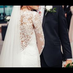 the bride and groom are standing close together