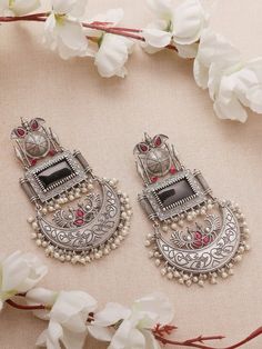 Step into a realm of timeless allure with our Black Pink Earrings, reminiscent of the majestic Chandbalis in stunning silver replica. 

Crafted with meticulous attention to detail, each piece reflects the intricate craftsmanship of eras past, while the vibrant black and pink stones add a touch of sophistication and allure. Whether you're attending a grand affair or seeking to elevate your everyday ensemble, these Chandbalis promise to leave a lasting impression.

Elevate your style effortlessly with these exquisite earrings, capturing the essence of tradition and luxury in every curve and contour. Embrace the opulence of royalty and make a bold fashion statement with our captivating Black Pink Chandbali Earrings, destined to be the crowning jewel of your collection.

In case of any queries Traditional Jhumkas, Trendy Silver Jewelry, Pakistani Jewellery, Earrings Outfit, Pretty Jewelry Necklaces, Pink Stones, Fancy Jewellery Designs, Silver Jewellery Indian, Jewellery Indian