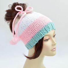 a mannequin head wearing a pink, white and blue knitted hat with a bow