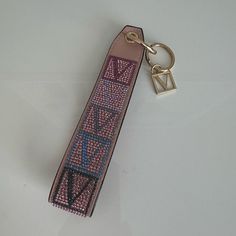 a keychain that has been decorated with pink and blue beads