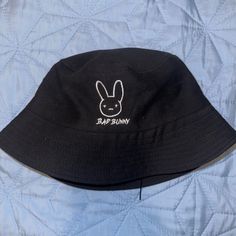 Brand New Never Worn Unisex Badbunny Bucket Hat, Trendy Black Bucket Hat For Spring, Black Cotton Bucket Hat For Vacation, Casual Black Wide Brim Bucket Hat, Casual Black Summer Hat, Trendy Black Bucket Hat With Short Brim, Trendy Black Bucket Hat For Streetwear, Black Spring Bucket Hat, Casual Black Bucket Hat For Vacation