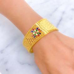 This 22k gold screw bangle weighs 47.7 grams and is adorned with vibrant Meenakari flower designs, giving it a colorful and artistic flair. The bangle has a size of 2.5 inches and an opening diameter of 2.3 inches, featuring a secure screw with hinge mechanism for easy opening and closing. This exquisite piece combines traditional Meenakari artistry with the timeless appeal of gold, making it a perfect accessory for adding a splash of color and elegance to any outfit. PRODUCT DETAILS Gold Purity(karat): 22k Gold Weight(grams): 47.7 Item Finish: Yellow Gold Bangle Size: 2.5 Bangle Opening(diameter): 2.3" Openable: Yes, Screw w/ Hinge Number Of Pieces: 1 Bangle Bridal Jewelry Necklace, Precious Stones Rings, Diamond Pendant Sets, Yellow Gold Bangle, Fancy Necklace, Fancy Rings, Mens Gold Rings, Diamond Necklace Set, Stone Bangle