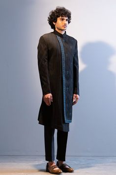 Black achkan style sherwani with floral embroidered motifs, highlighted with dabka work and pintuck asymmetric panel. Paired with pant.
Component: 2
Embroidered
Neckline: Band
Sleeve Length: Full
Fabric: Slub Silk, Cotton Silk
Color: Black
Asymmetric panel - Aza Fashions Fitted Resham Embroidery Kurta For Semi-formal Occasions, Designer Sherwani With Resham Embroidery, Designer Straight Kurta Sherwani For Formal Occasions, Semi-formal Straight Kurta With Resham Embroidery, Designer Fitted Sherwani With Traditional Drape, Festive Semi-formal Kurta With Traditional Drape, Designer Bandhgala With Resham Embroidery For Semi-formal Occasions, Designer Embroidered Bandhgala For Semi-formal Occasions, Designer Embroidered Bandhgala For Semi-formal Events