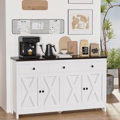 there is a coffee maker on top of the white sideboard in this living room