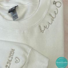 a white shirt with the word love written on it and a pair of scissors next to it