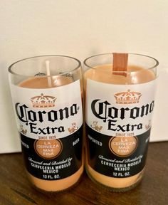 two glasses with corona extra on them sitting next to each other