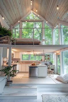 an open floor plan with high ceilings and lots of windows