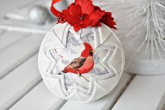 a christmas ornament with a cardinal on it