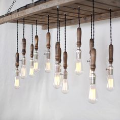 a bunch of light bulbs hanging from a wooden beam