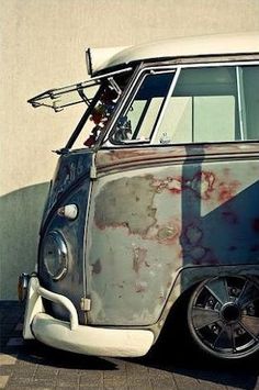 an old vw bus parked in front of a building