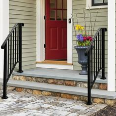 a red door and some flowers on the steps