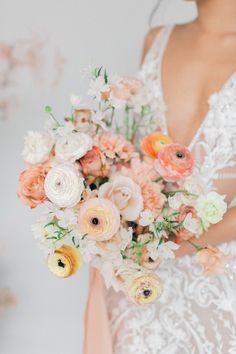 a woman holding a bouquet of flowers in her hands